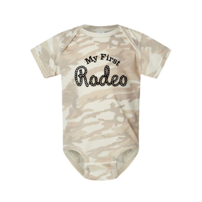 Infant camo onesie with "My First Rodeo" rope-style lettering on front